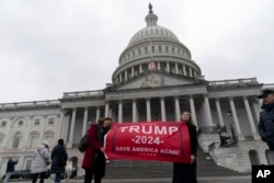 Supporters of President-elect Donald Trump take pictures as they celebrate outside of the U.S. Capitol in Washington, Jan. 19, 2025.